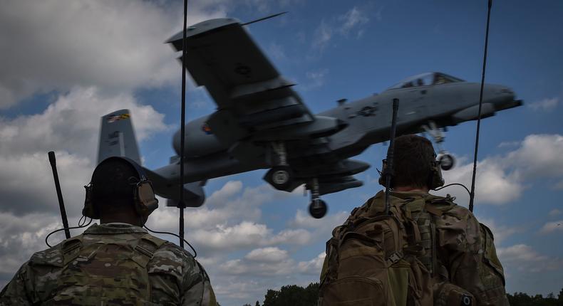 Combat controllers with the 321st Special Tactics Squadron watch an A-10 land on a highway in Estonia, August 10, 2017.
