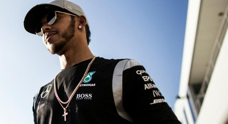 Mercedes driver Lewis Hamilton of Britain looks on after talking to the media during the Formula One Japanese Grand Prix in Suzuka on October 6, 2016