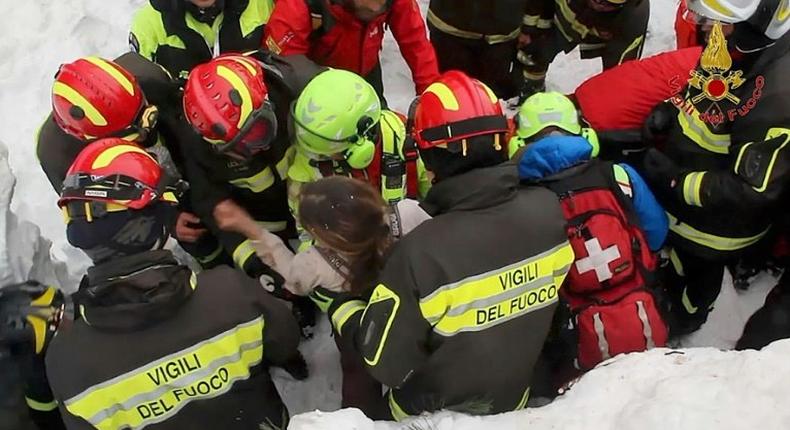 A woman is rescued from the Hotel Rigopiano, near the village of Farindola, on the eastern lower slopes of the Gran Sasso mountain