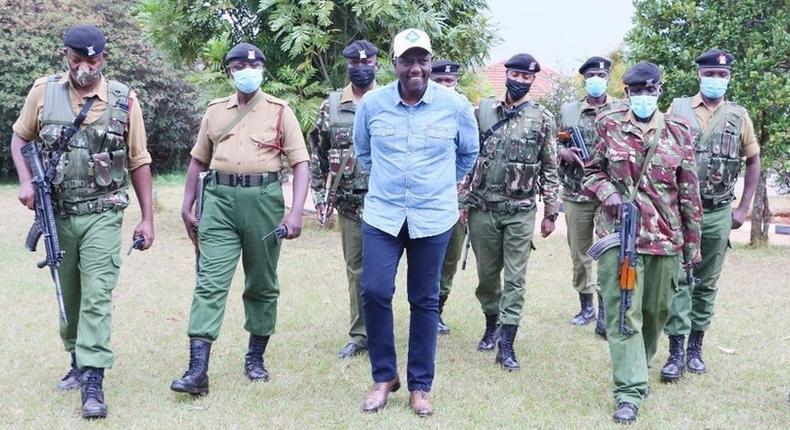 Deputy President William Ruto with police officers attached to his official residence in Karen