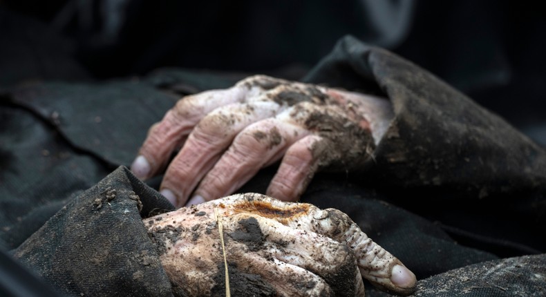 A view of the corpse of a civilian killed, before being transported to the morgue, in the cemetery in Bucha, on the outskirts of Kyiv, Ukraine, Wednesday, April 6, 2022.