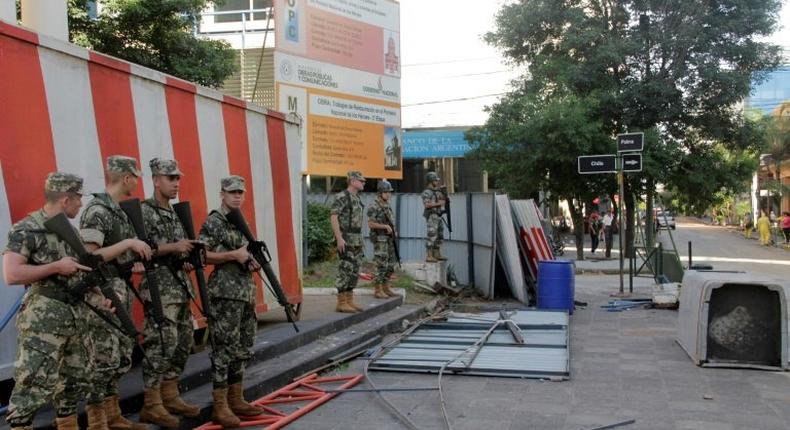 Police guard the area around Government House in Asuncion, after demonstrators set fire to the Congress building during protests over a constitutional amendment