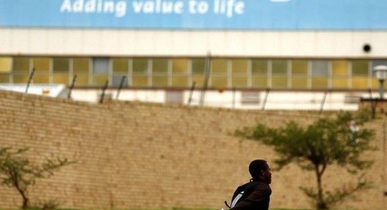 A man runs past the Adcock Ingram offices in Johannesburg December 3, 2013. 