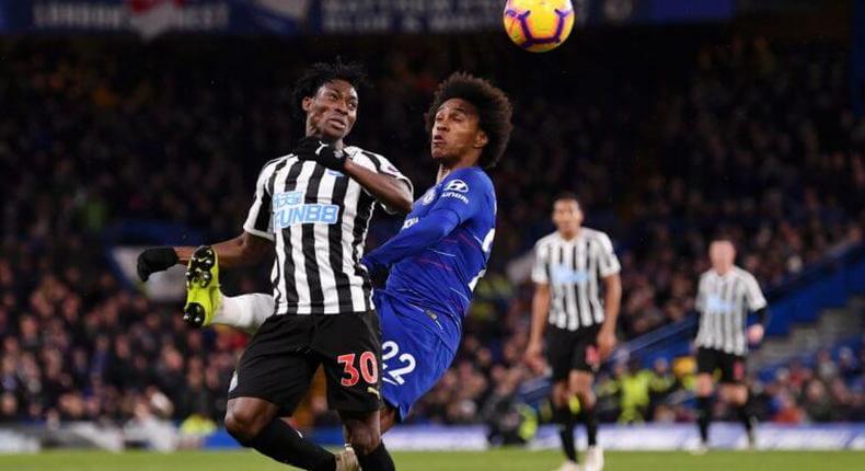 Christian Atsu fights for the ball with Chelsea's Willian