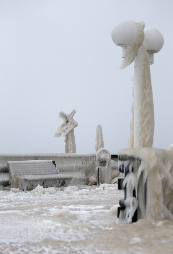 Benches on a sea bridge are covered with ice at the Baltic Sea village of Scharbeutz