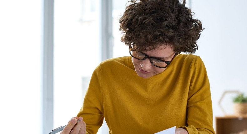 woman signing a document