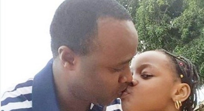 Femi Adebayo kissing his daughter 