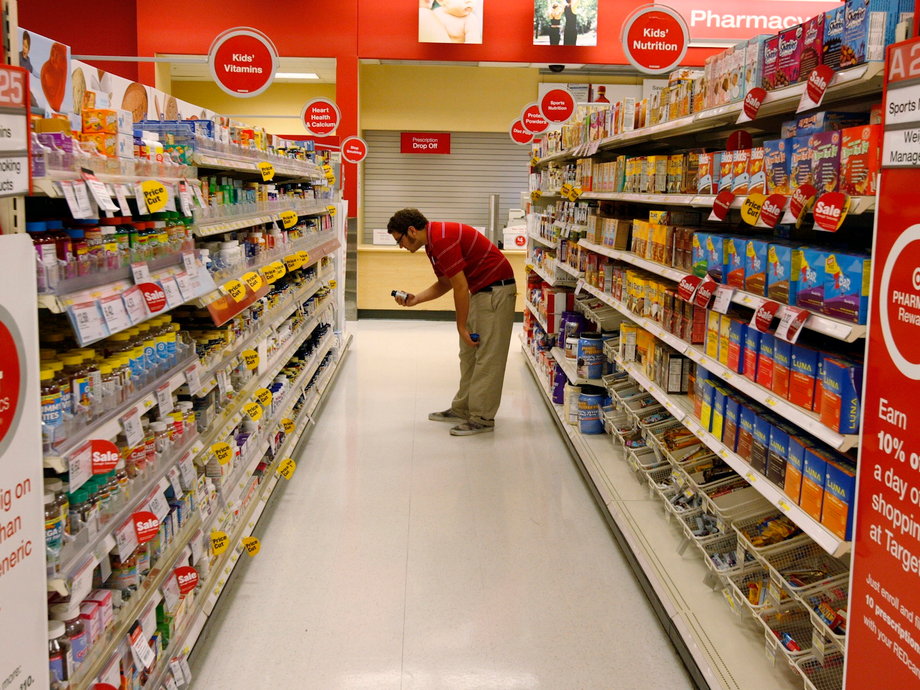 A Target store team member places an item back on the shelf near the pharmacy department at a Target store in Los Angeles, California August 18, 2009.