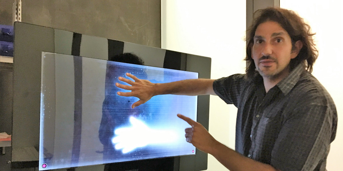 Microsoft Distinguished Scientist Stevie Bathiche, co-inventor of the original Surface table, shows off the Samsung SUR40 giant tablet.