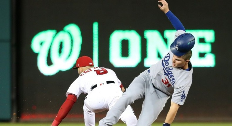 Joc Pederson of the Los Angeles Dodgers advances to second base against Danny Espinosa of the Washington Nationals on October 13, 2016 in Washington, DC