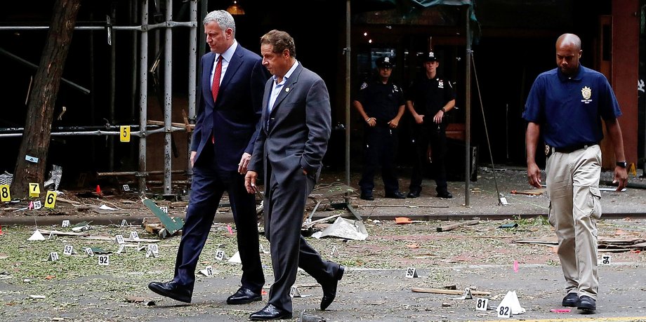 New York Mayor Bill de Blasio (L) and New York Governor Andrew Cuomo (R) tour the site of an explosion that occurred in the Chelsea neighborhood of New York