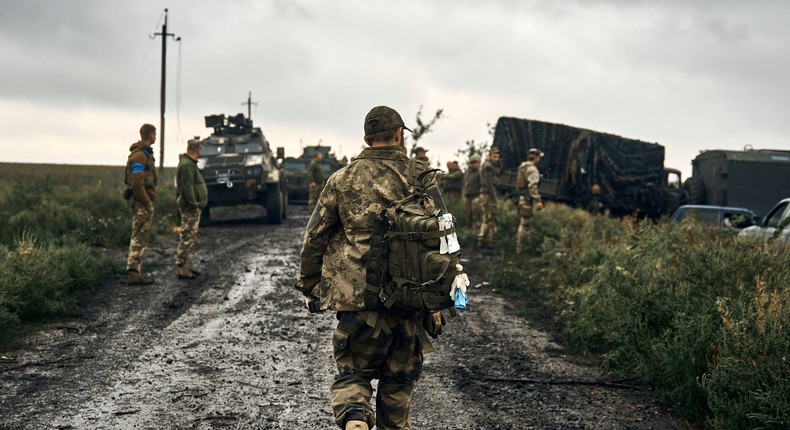 Ukrainian soldiers stand on the road in the freed territory of the Kharkiv region, Ukraine, Monday, Sept. 12, 2022.