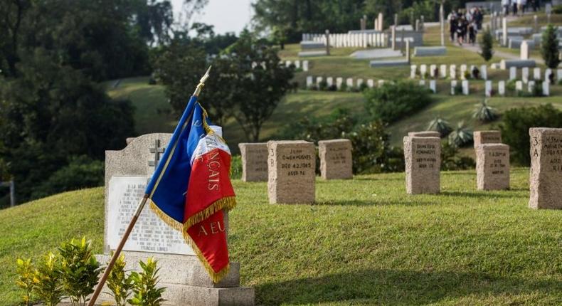 A French flag is draped over a memorial at the Stanley Military Cemetery, dedicated to French civilians who died fighting with the Hong Kong Volunteer Defence Corps against the 1941 Japanese invasion of the territory