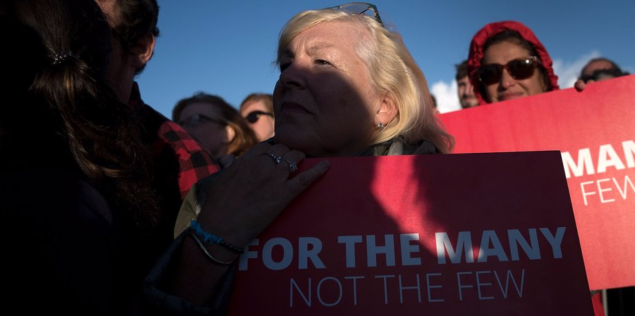 Supporters listen to Labour Party Leader Jeremy Corbyn as he addresses a rally