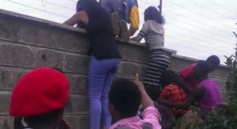 File image of teenagers attempting to jump over a fence during a previous raid