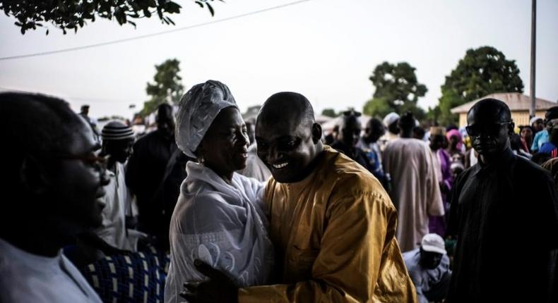 Gambian opposition figure Isatou Touray (L) greets the flag-bearer of the coalition of seven opposition political parties, Adama Barrow, at a gathering in Jambur on November 26, 2016 ahead of December 1 presidential elections