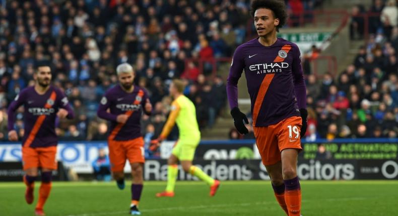 Leroy Sane (R) celebrates after finishing a finishing a fine move to score the third goal in Manchester City's 3-0 win away to Huddersfield on Sunday