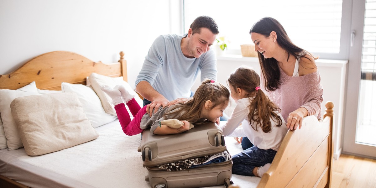 Young family with two children packing for holiday.