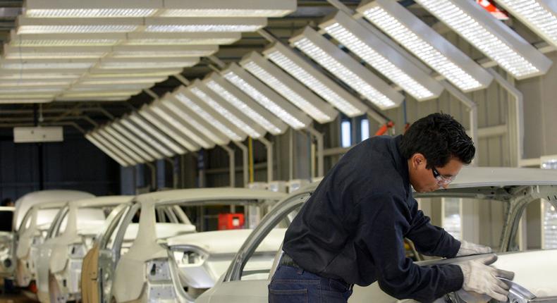 An employee works on the assembly line at the Volkswagen (VW) automobile manufacturing factory in Puebla August 12, 2010. Puebla, which will manufacture over half a million vehicles every year, is VW's largest factory in the Americas and one of the largest worldwide.