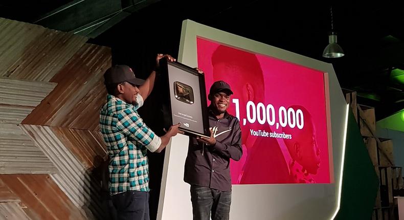 Comedian Mark Angel receiving the gold-plated YouTube plaque at Google For Nigeria for hitting 1 million YouTube subscribers, the first Nigerian-owned channel to do so. 