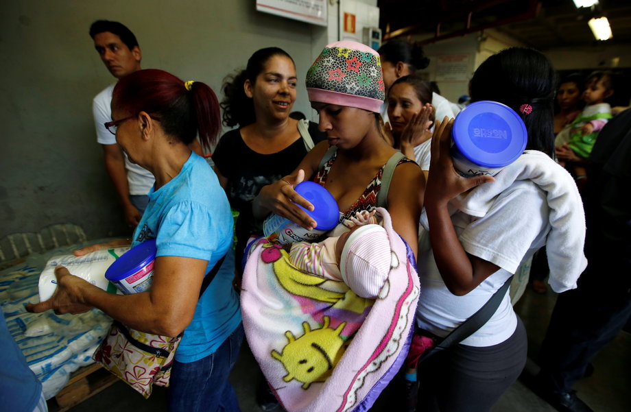 People buy food and other staple goods inside a supermarket in Caracas, Venezuela, June 30, 2016.