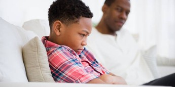 Father and son arguing in a sofa