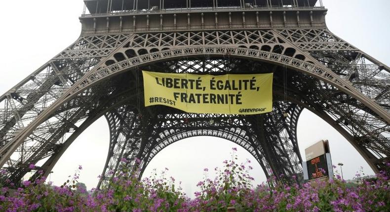A Greenpeace banner at the Eiffel Tower recalls the values of the French republic -- liberty, equality, fraternity -- in protest against the far-right National Front of Marine Le Pen, who faces centrist Emmanuel Macron in Sunday's election
