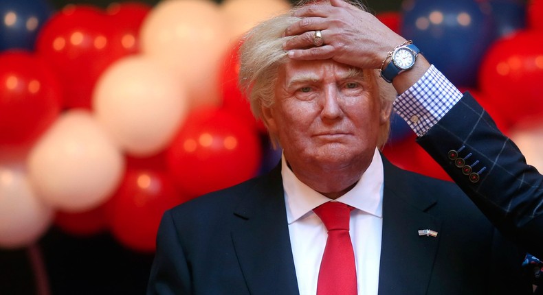 A museum worker fixing the hair of a life-size wax statue of US President-elect Donald Trump during an unveiling ceremony at a wax museum in Madrid, Spain.