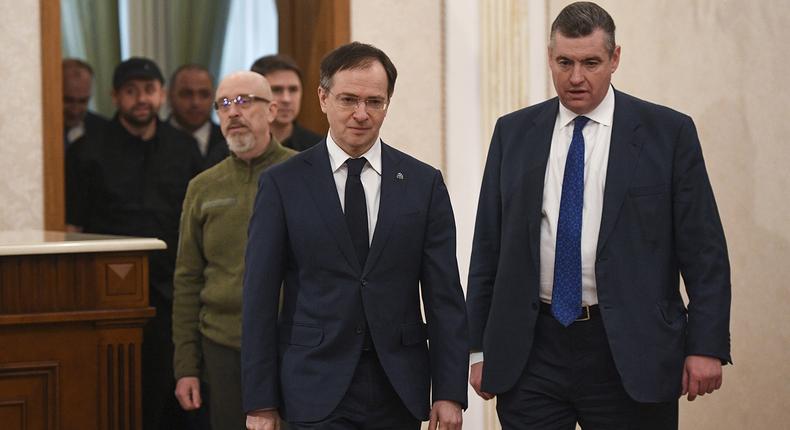 Russian Presidential Aide Vladimir Medinsky, left, and Russian State Duma member Leonid Slutsky, followed by the Ukrainian delegation arrive for Russian-Ukrainian talks in Belarus on February 28. (Alexandr Kryazhev/ Sputnik/AP)