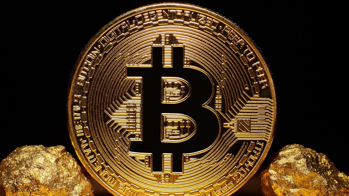 Golden Bitcoin Coin and mound of gold on black background