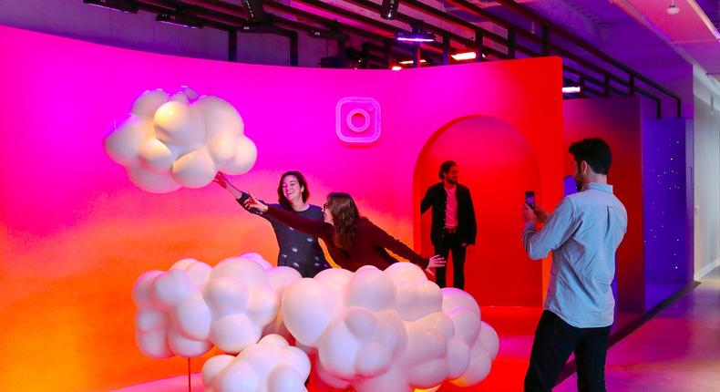 People pose for a photo inside Instagram's headquarters.