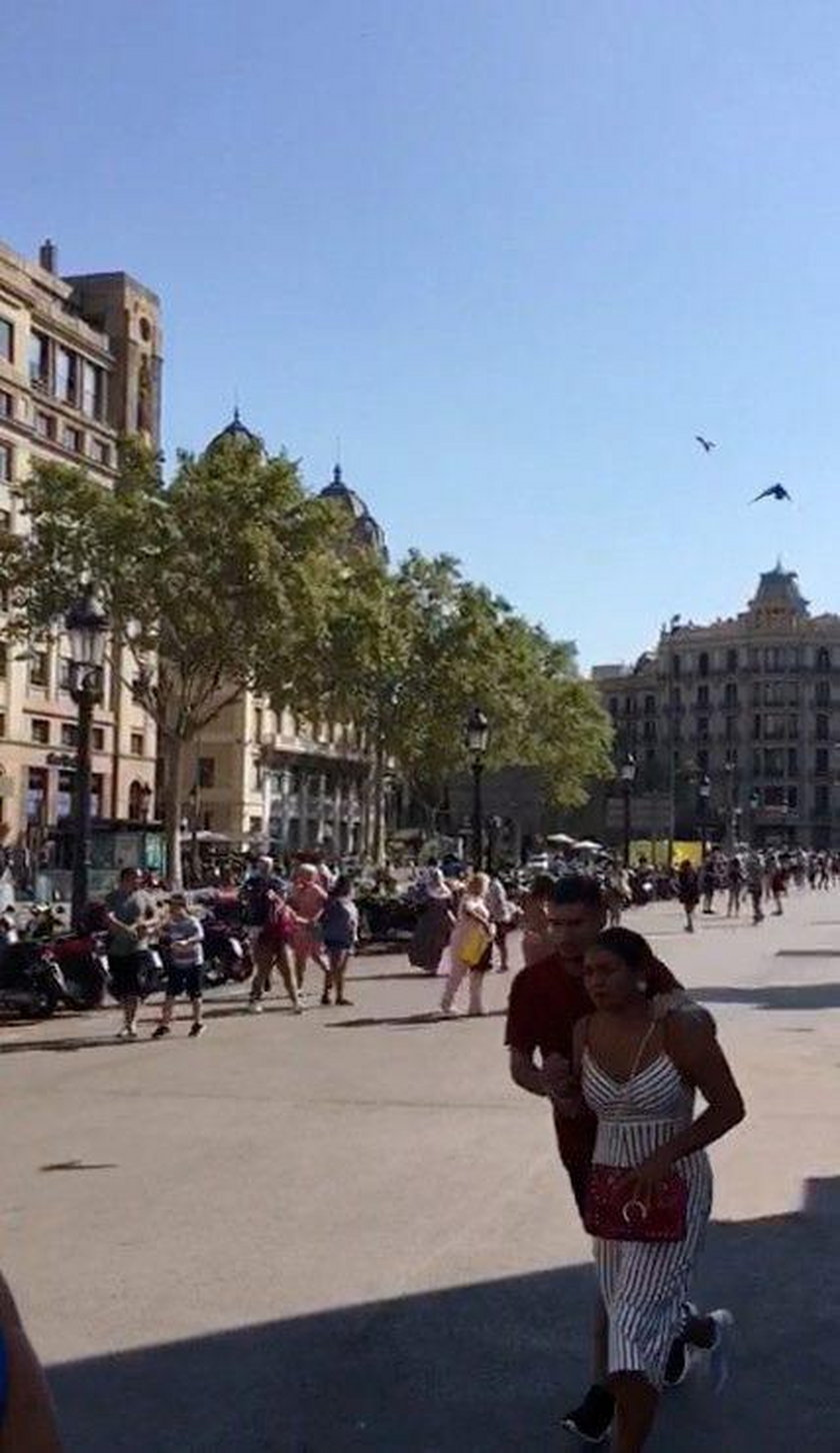 People run away after a van crashed into pedestrians near the Las Ramblas avenue in central Barcelon