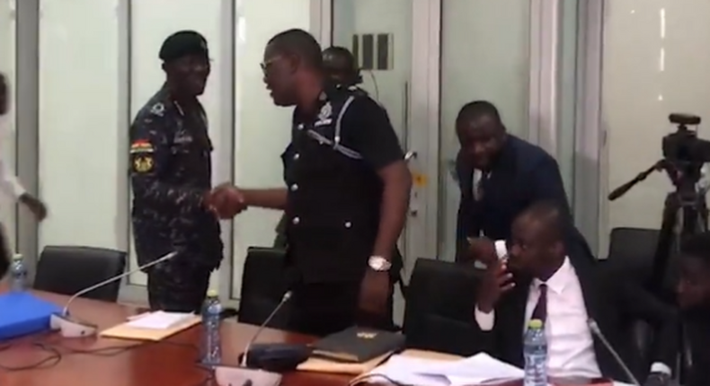 IGP Dampare exchanges pleasantries in a handshake with Supt. Asare wants him removed