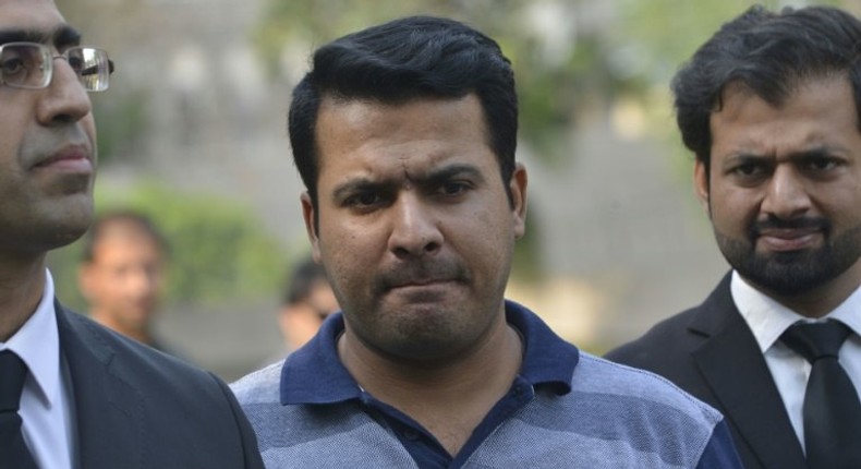 Suspended Pakistani cricketer Sharjeel Khan leaves with his lawyers after appearing before a tribunal in Lahore on May 18, 2017