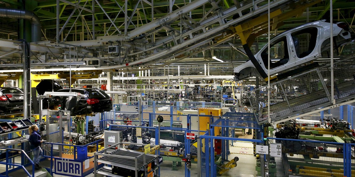 An employee of German car manufacturer Mercedes Benz observes the connection between the bodywork and the chassis of an A class (A-Klasse) model at their production line at the factory in Rastatt