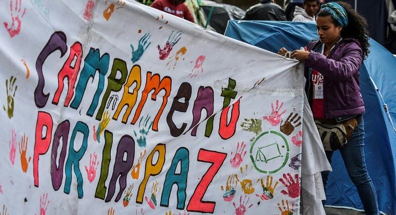 A tent sign reading Camping for peace during a demonstration to push for immediate implementation of a peace accord between the Colombian government and FARC guerrillas