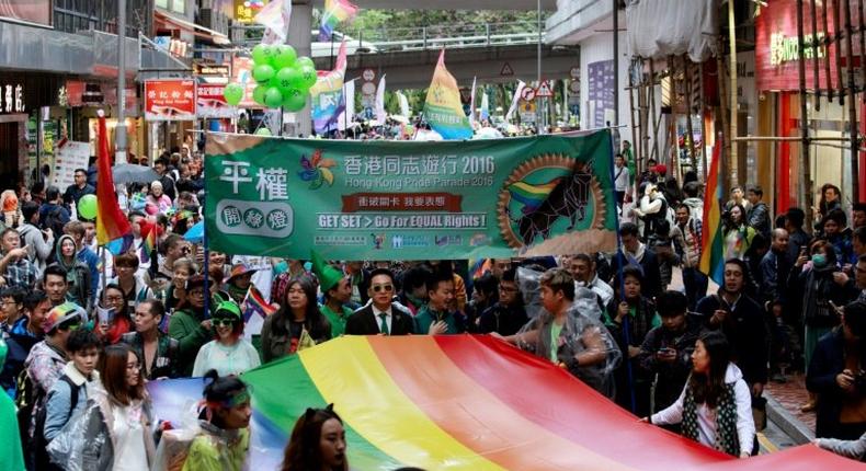 Participants, many from Hong Kong's LGBT community, take part in their annual pride parade through the streets with a large rainbow flag on November 26, 2016