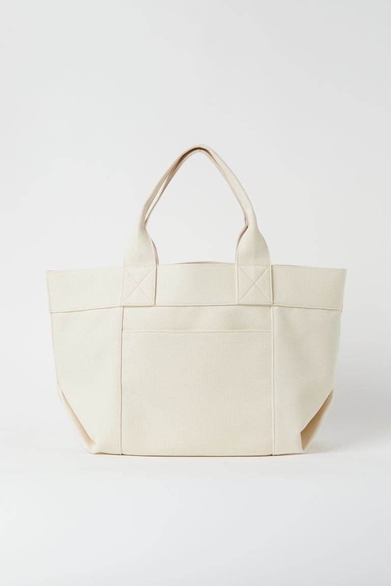 Cabas en toile couleur crème de H&M pour CHF 49.95.