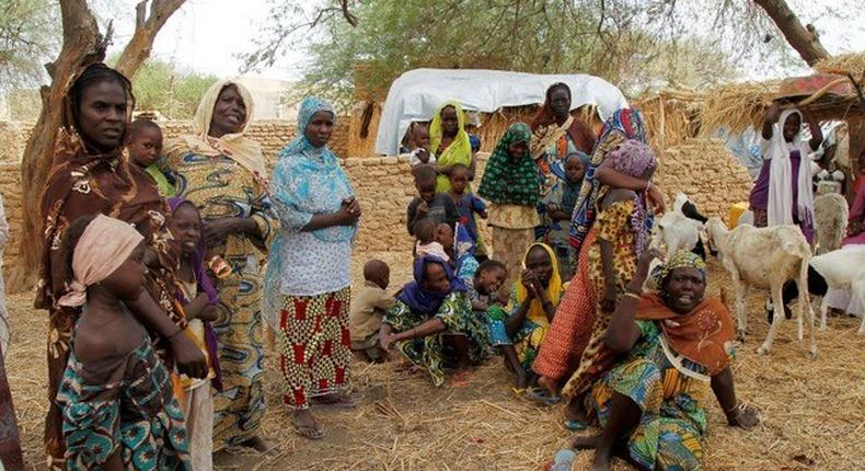 Nigerian refugees, who fled from their village into Niger following Boko Haram attacks, stand in the yard of their Nigerien host in Diffa in southeastern Niger June 21, 2016.