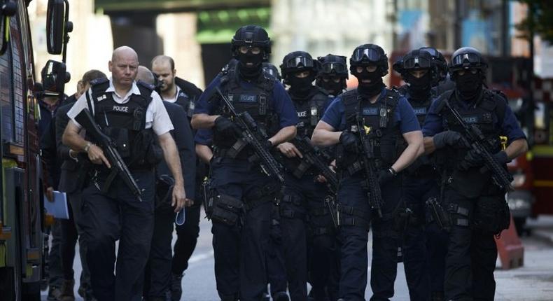 Armed police officers patrol on the streets of London on June 4, 2017 following a terror attack the previous evening