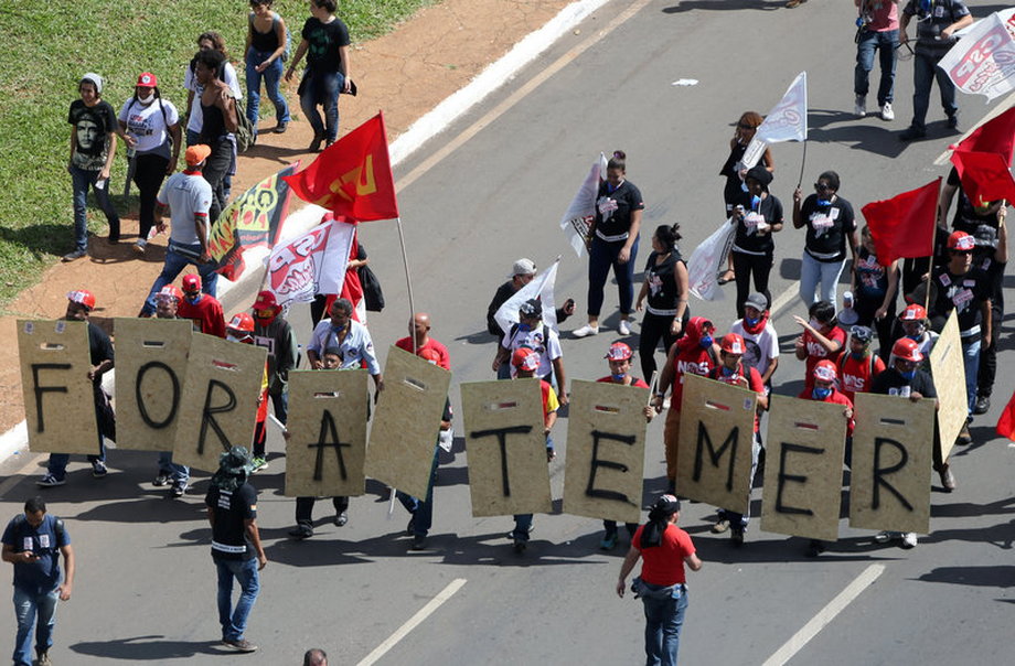 Demonstrators protest against Brazilian President Michel Temer and the latest corruption scandal to hit the country, in Brasilia, May 24, 2017. The sign reads "Temer out!."