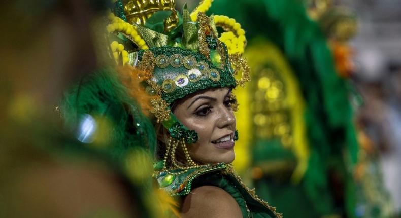 A reveller of Unidos de Vila Maria samba school performs during the second night of carnival in Sao Paulo