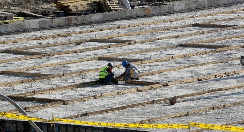 The particles are understood to be the product of uranium which has been mined and undergone initial processing, but not enriched; A picture taken on November 10, 2019, shows workers on the construction site of a second reactor in the Bushehr nuclear plant