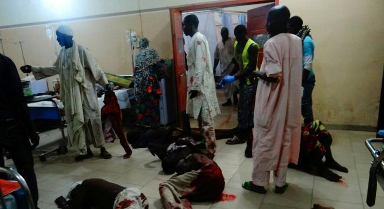 Injured victims of a female suicide bomber lie on the floor awaiting medical attention as beds were no longer available at a Maiduguri hospital in northeastern Nigeria