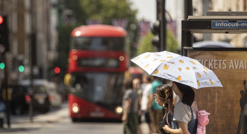 People shielding themselves from the heat in London, United Kingdom on July 18, 2022.