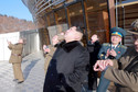 North Korean leader Kim Jong Un (C) watches a long range rocket launch into the air in North Korea