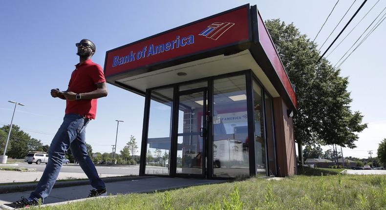 In this Monday, July 15, 2019 photo a customer departs a Bank of America ATM, in Norwood, Mass. Bank of America Corp. reports earnings Wednesday, July 17. (AP Photo/Steven Senne)