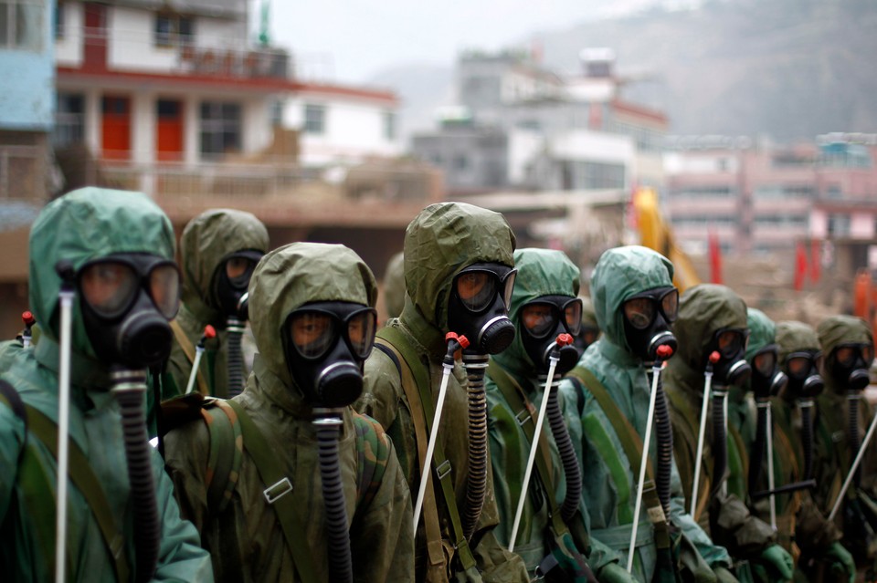 Rescuers prepare to disinfect a landslide-hit street in Zhouqu County of Gannan Tibetan Autonomous Prefecture