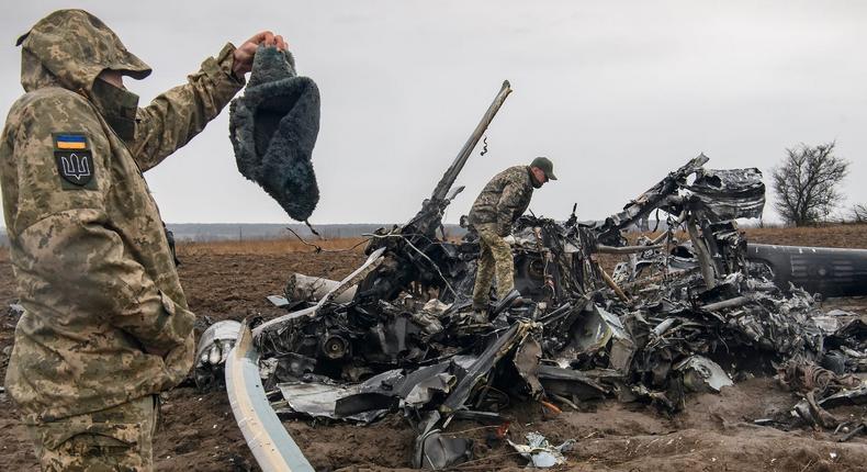 Ukrainian troops inspect a wrecked Russian Mi-8 helicopter near Kyiv, April 9, 2022.