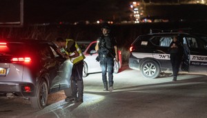 An Israeli soldier secures a road after a drone attack that killed four soldiers on October 13, 2024, near Binyamina, Israel.Ilia Yefimovich/picture alliance via Getty Images